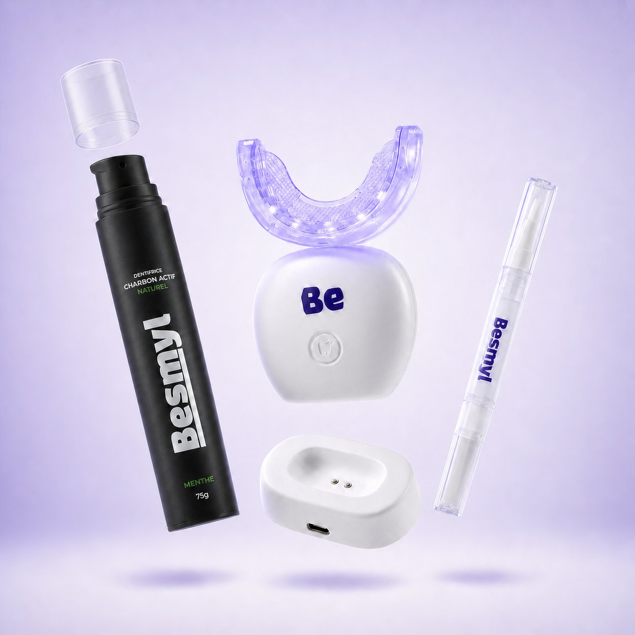 Vue éclatée de la box Besmyl : embout à lumière violette, base de charge, stylo PAP+ et dentifrice au charbon actif